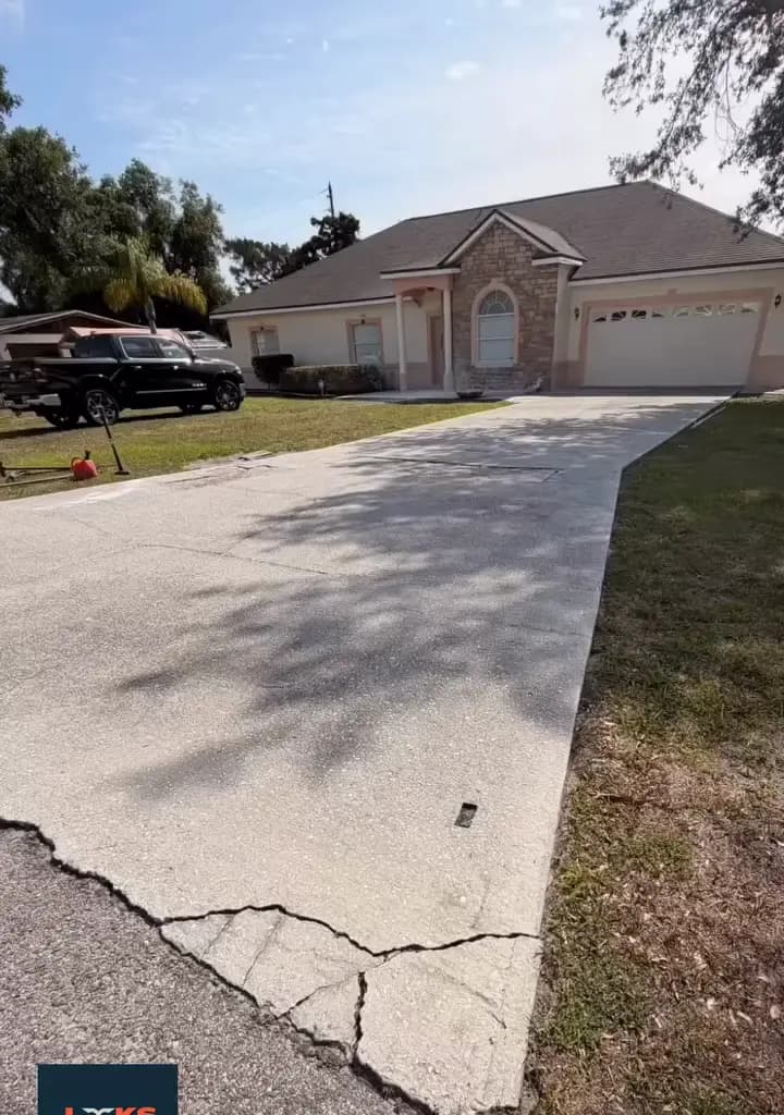 Cracked concrete driveway at a Central Florida home before replacement with pavers
