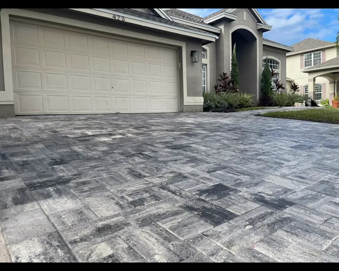 Gray paver driveway in front of a two car garage in Winter Garden, FL