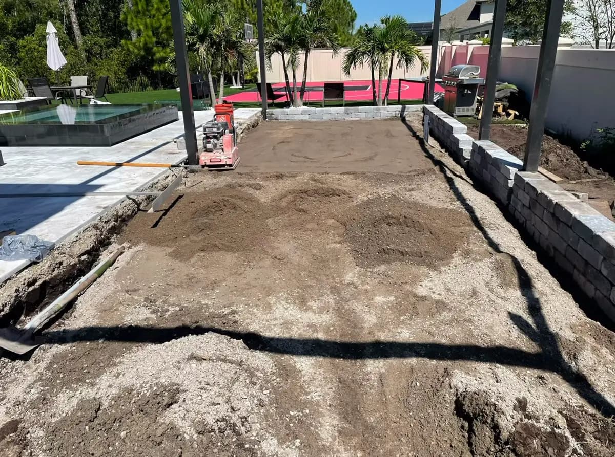 Compacted base and block wall ready for a new patio