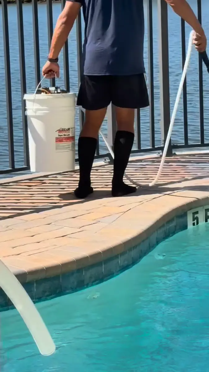 Paver sealer being applied to a pool deck at a Central Florida home