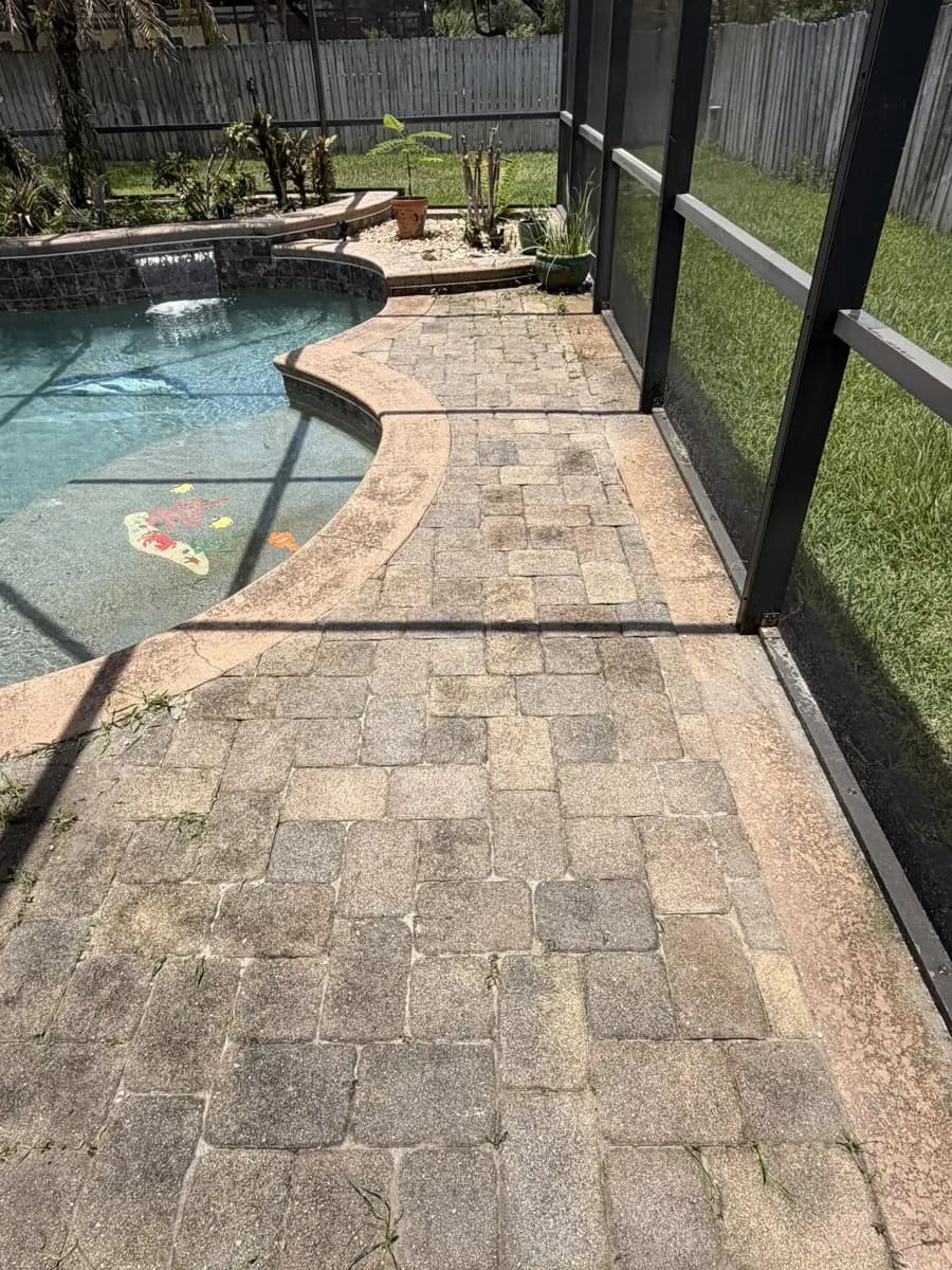 Pool deck pavers reset and repaired inside a screen enclosure
