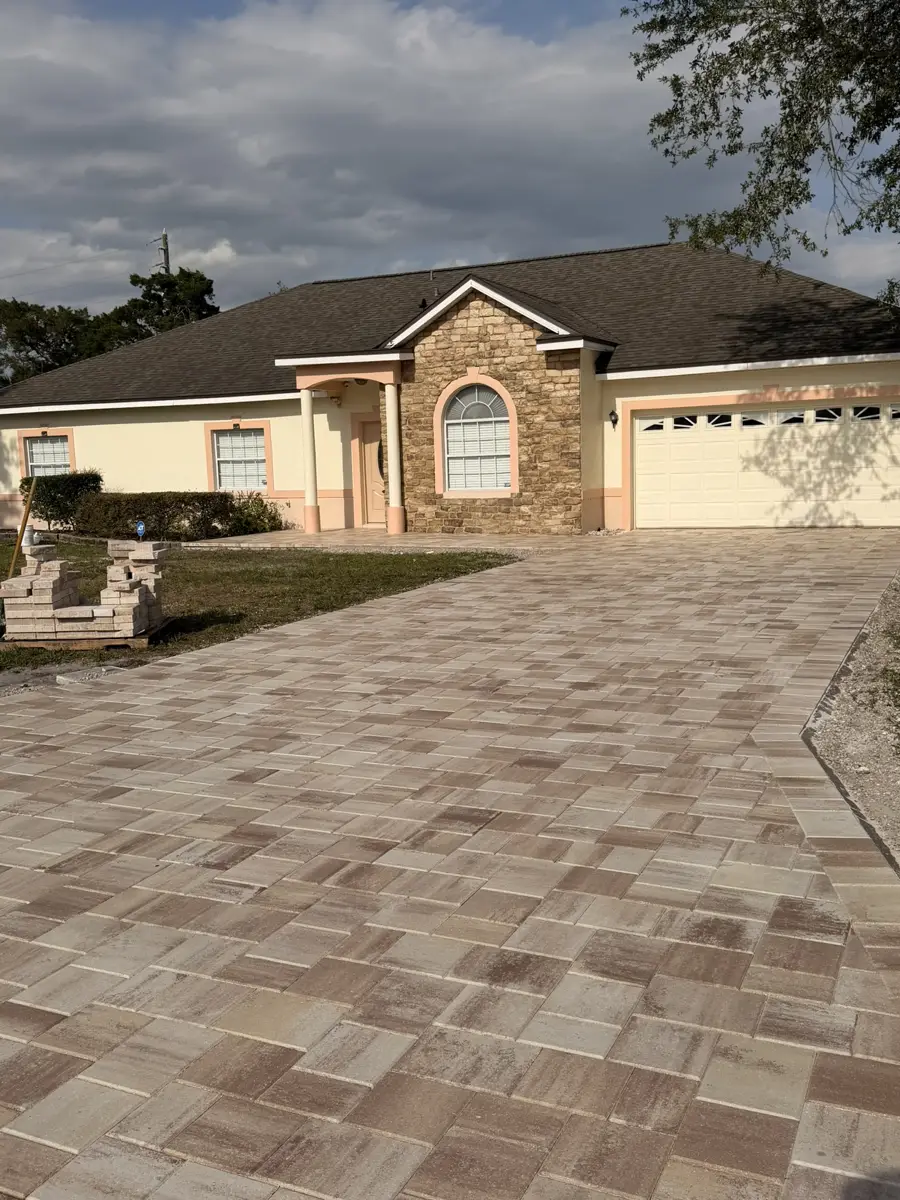 Tan paver driveway in front of a stone accent home in Central Florida