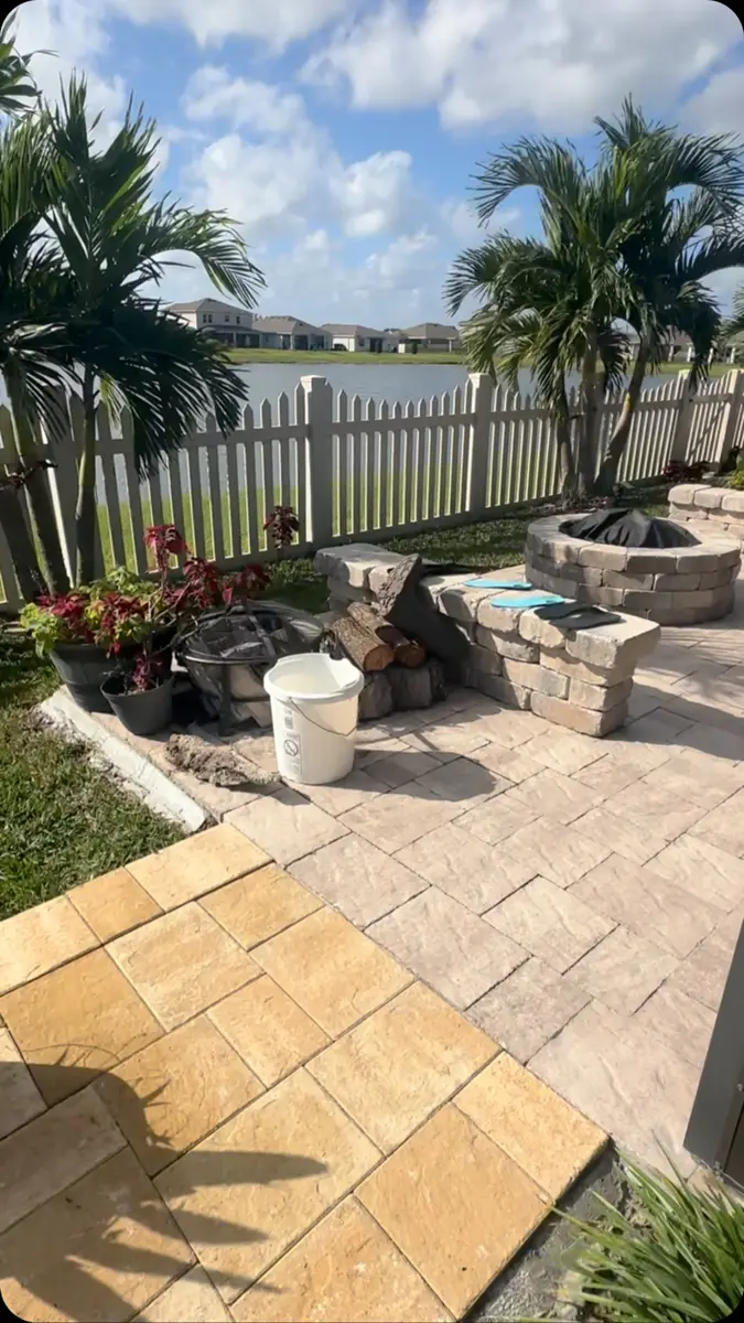 Travertine paver walkway leading to a lakefront home in Clermont, FL